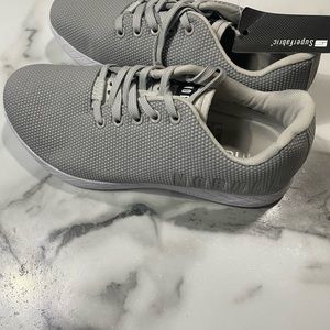 Grey  and white size 9.5 womens trainer shoe from Nobull.